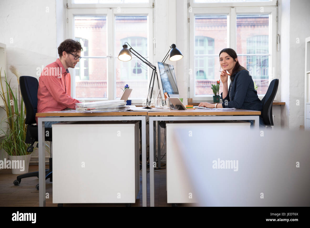 Man and woman working in office Stock Photo - Alamy