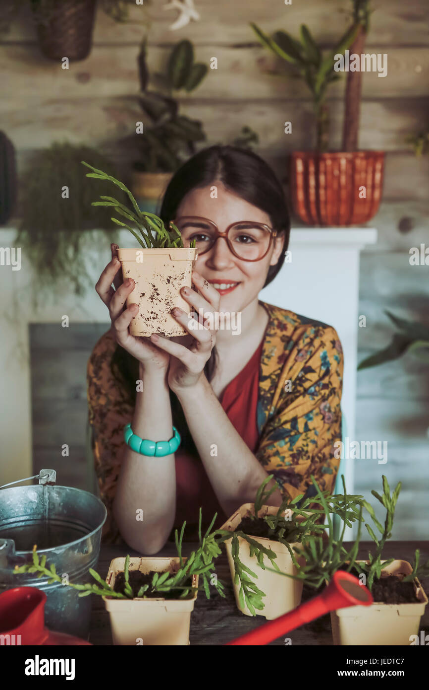 Young woman holding freshly potted cactus Stock Photo