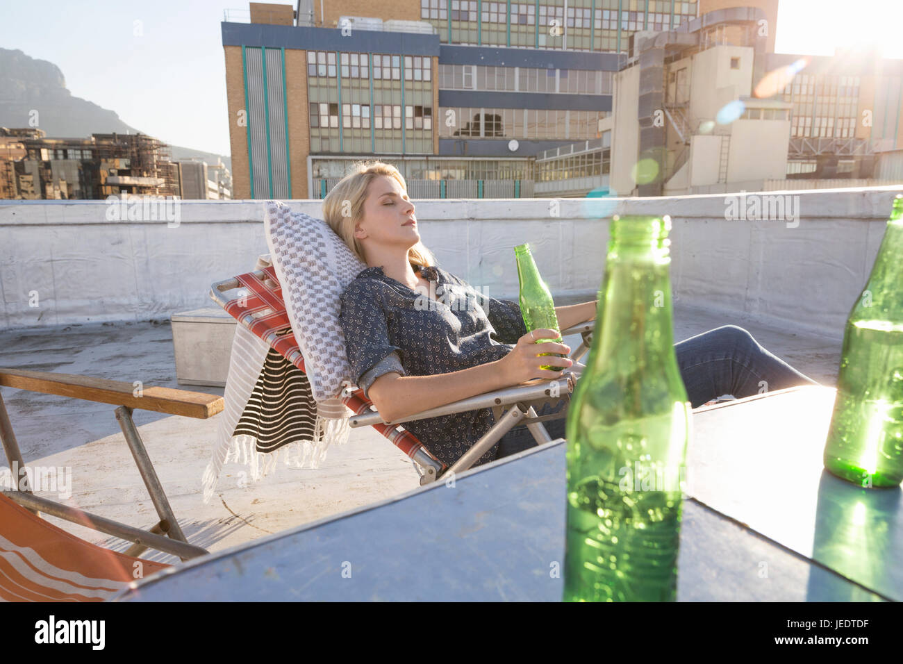 Young woman relaxing on her terrace Stock Photo - Alamy