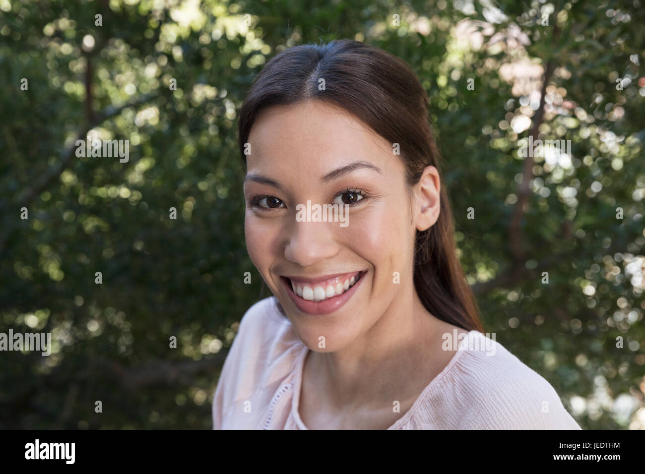 Portrait of smiling young woman outdoors Stock Photo - Alamy