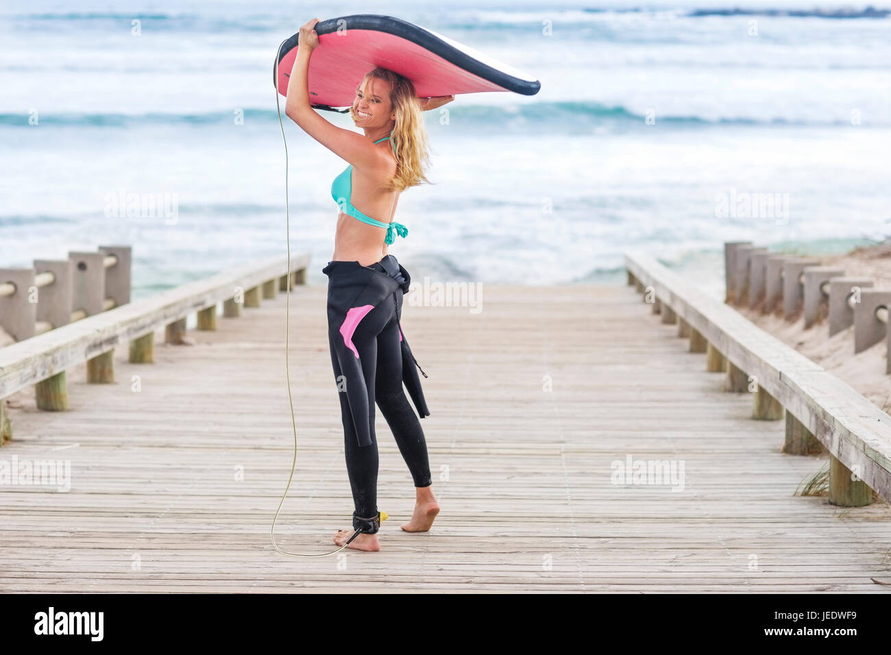 Laughing woman holding surfboard hi-res stock photography and images ...