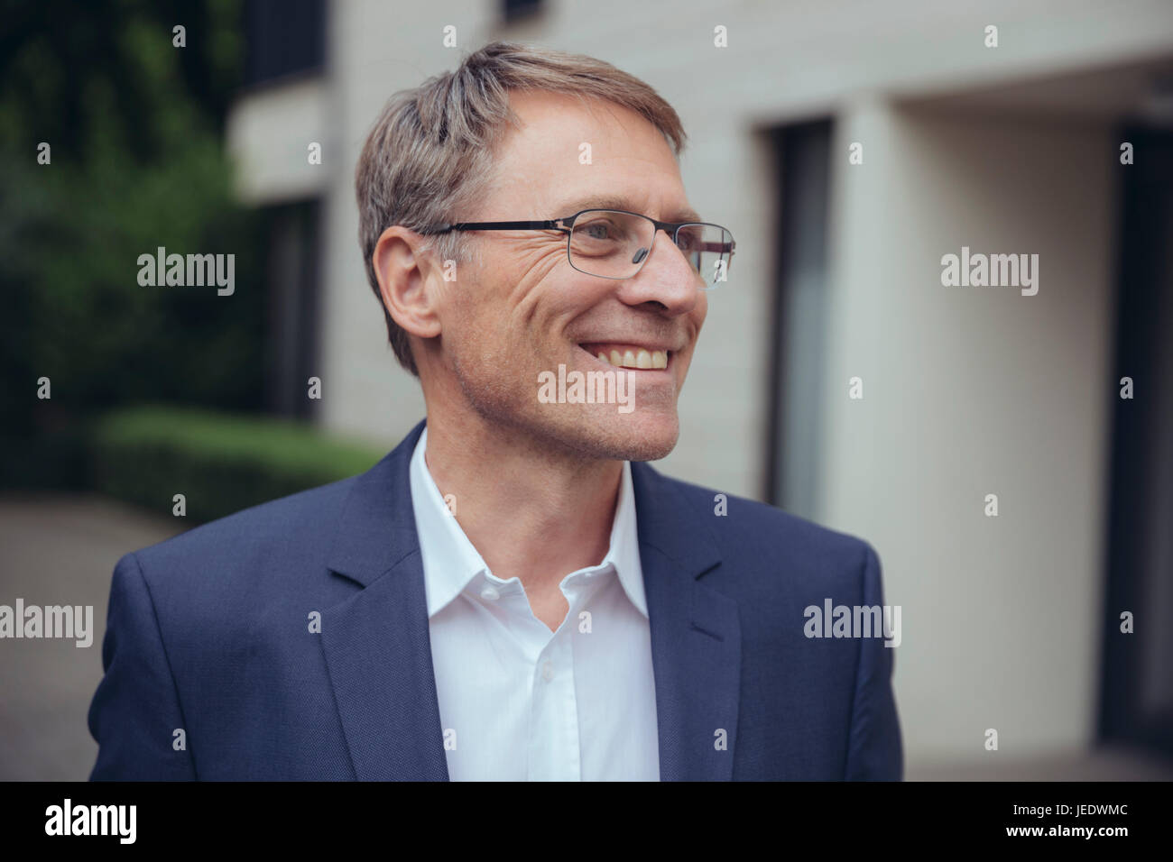 Portrait of smiling mature businessman outdoors Stock Photo - Alamy