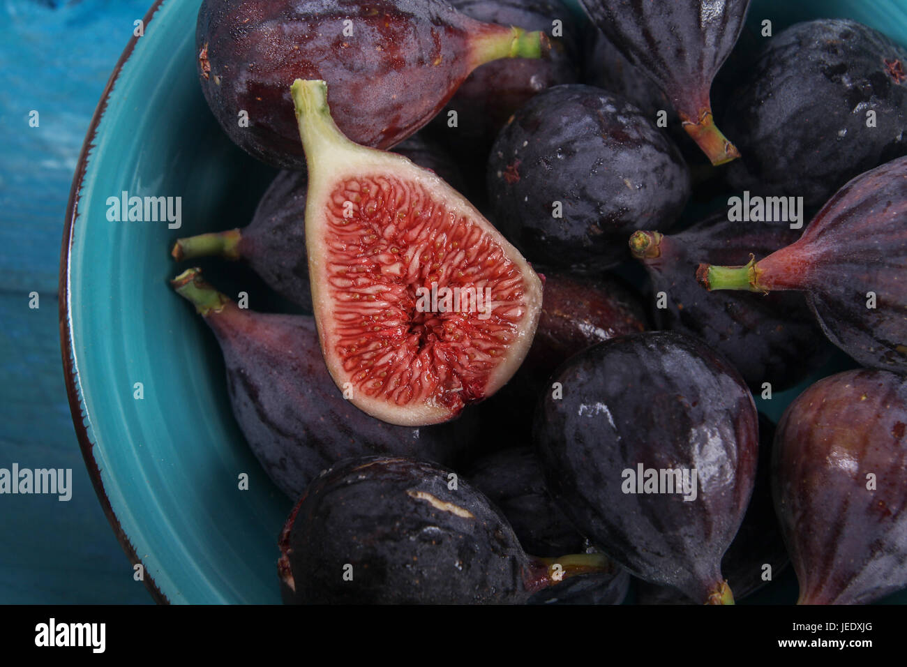 Sliced and whole figs in a bowl Stock Photo Alamy