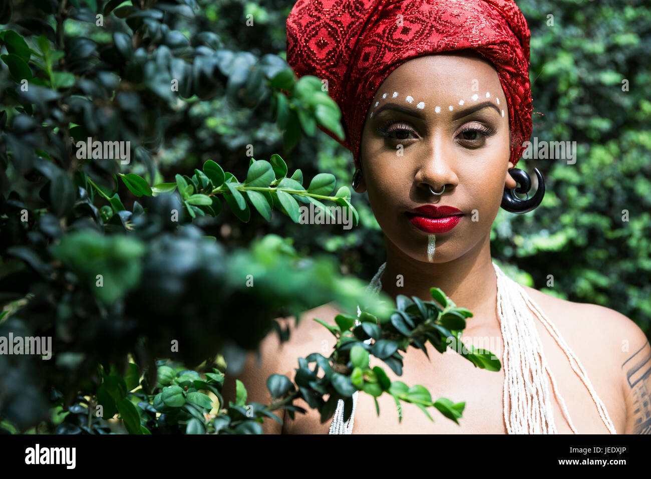 Portrait of young woman with piercings wearing traditional Brazilian headgear Stock Photo
