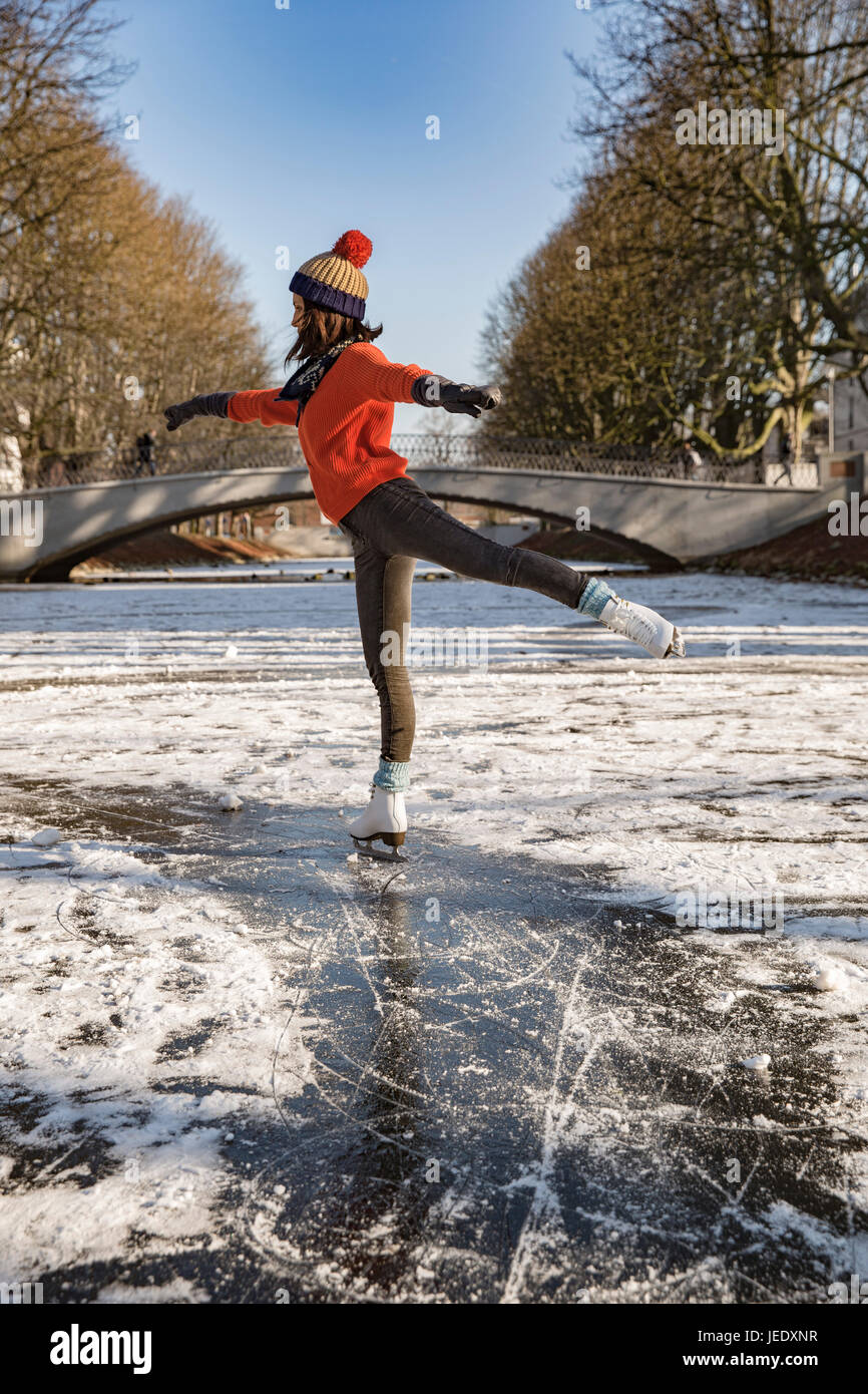 Woman ice skating on canal Stock Photo Alamy