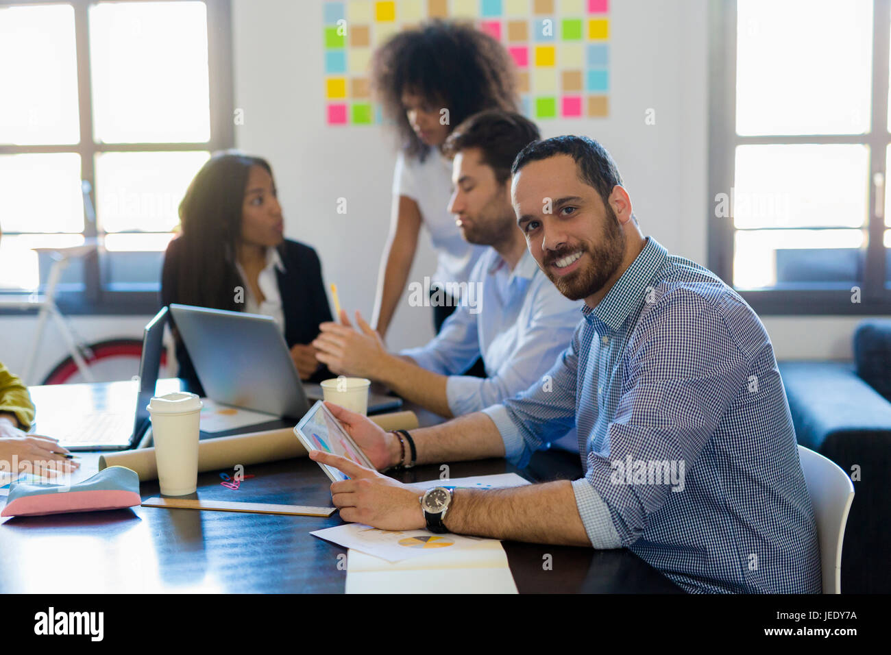 Portrait of smiling businessman during a meeting in office Stock Photo ...