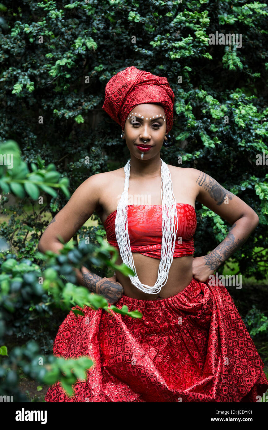 Portrait of young woman with piercings and tatoos wearing traditional Brazilian clothing Stock Photo