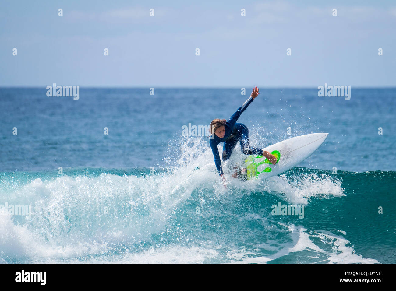 Boy surfing in the sea Stock Photo - Alamy