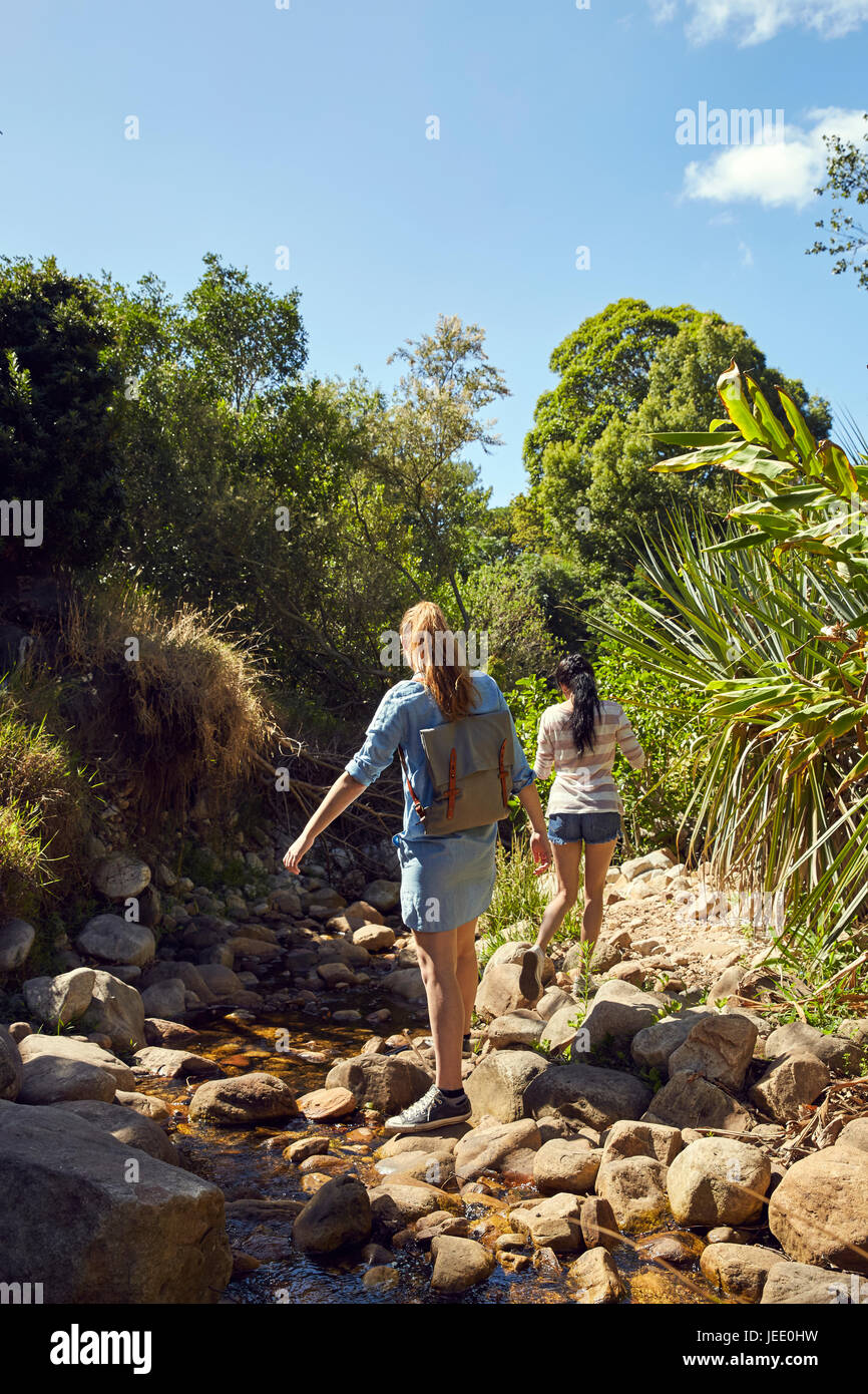 Back view of two young women walking in nature Stock Photo - Alamy
