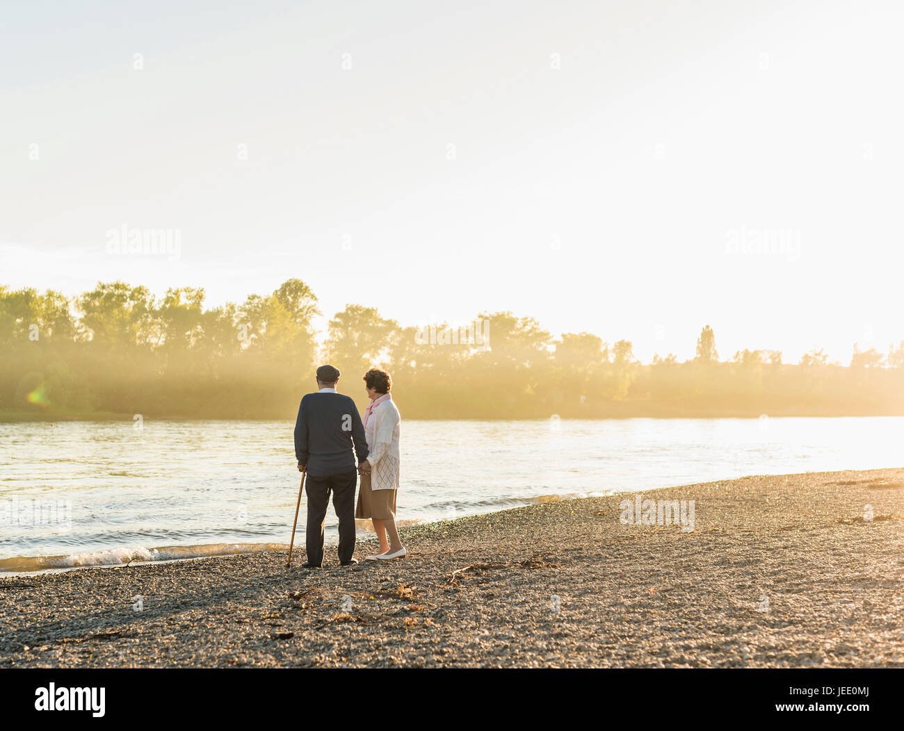 Relaxed man standing riverside looking view hi-res stock photography ...