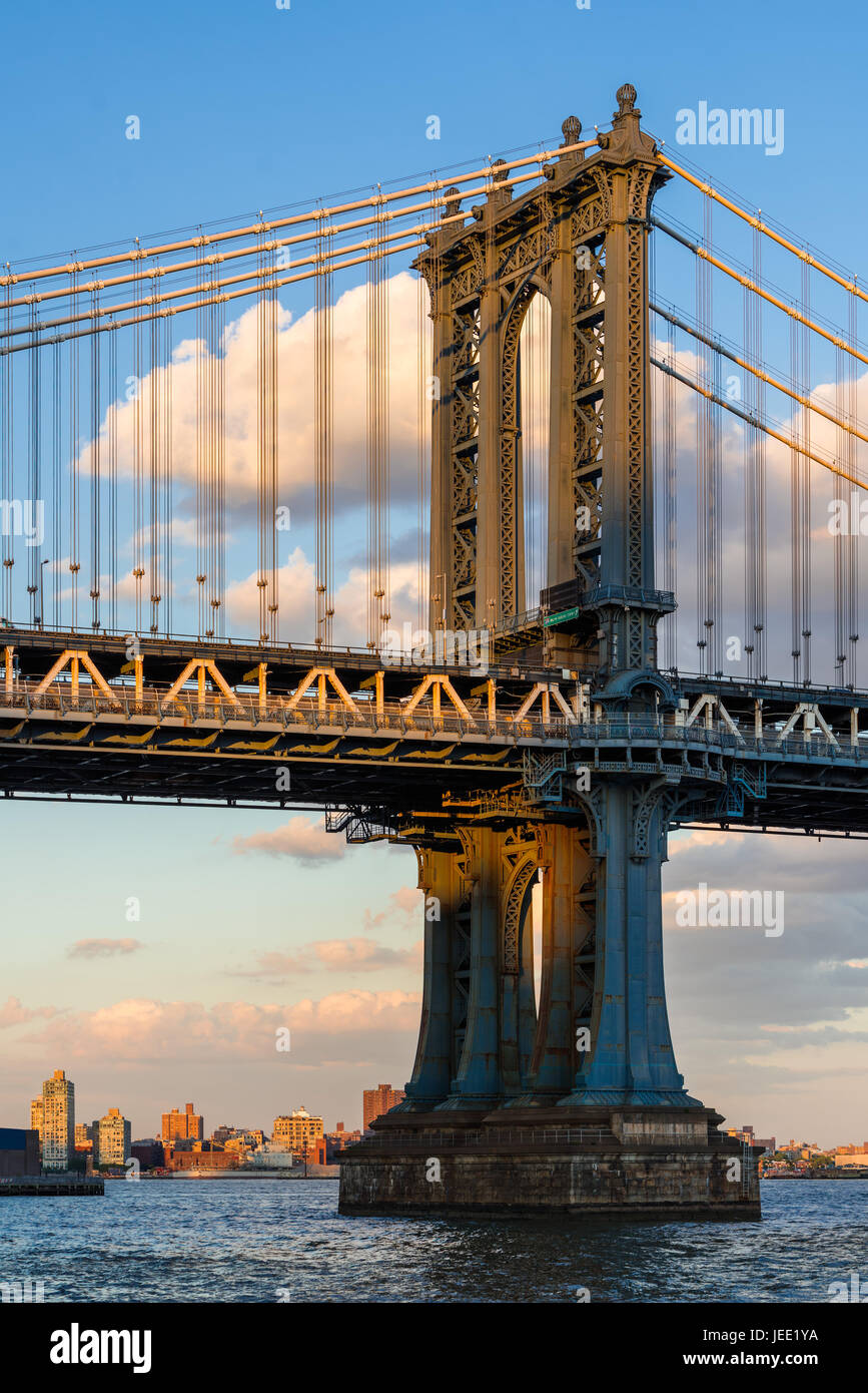 Detail of the Manhattan Bridge east tower over the East River at sunset. New York City Stock Photo