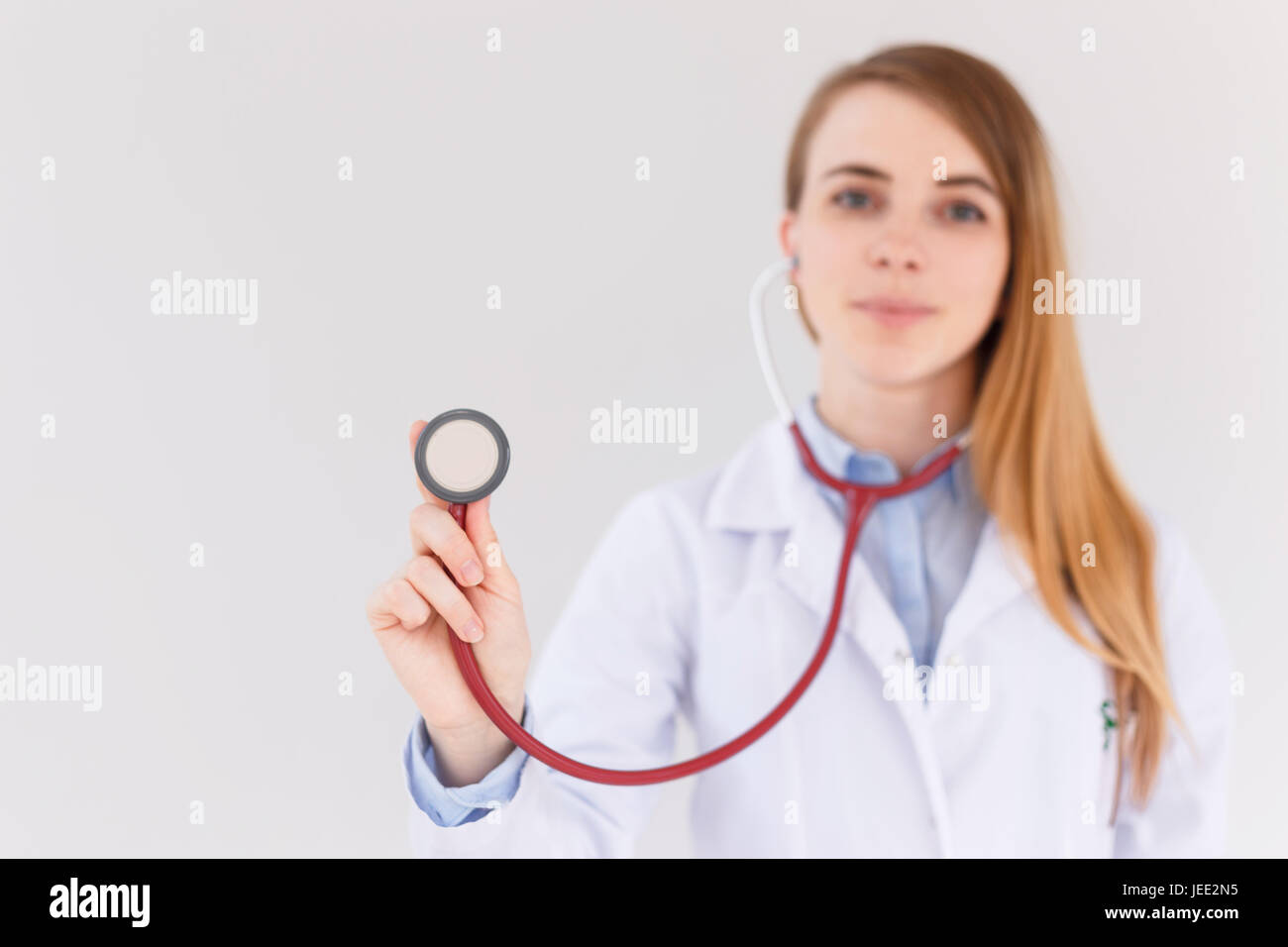Portrait of female doctor using stethoscope , focus on stethoscope ...