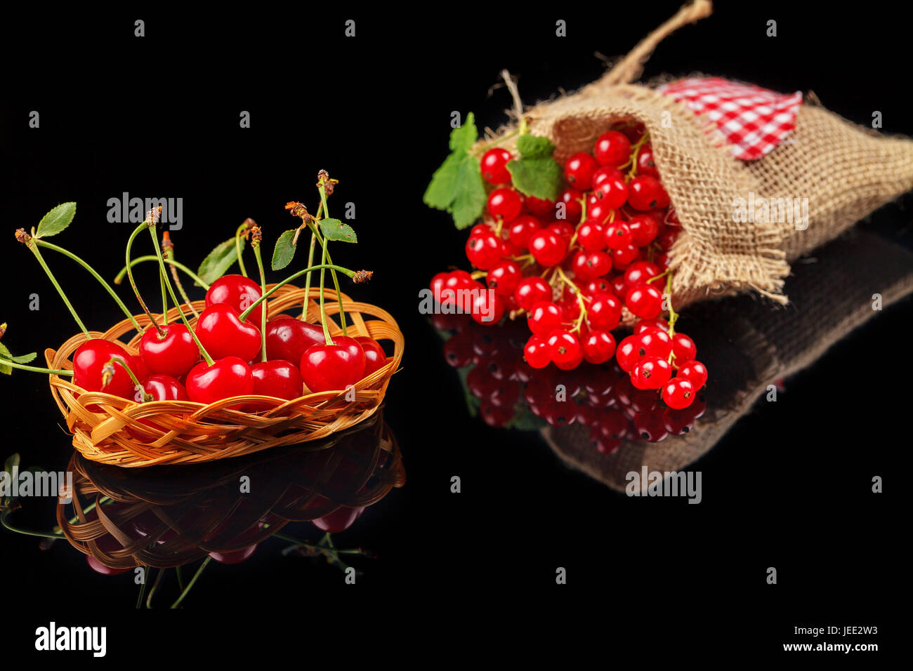 Fruits of cherry and red currant on a dark background. Close-up Stock Photo