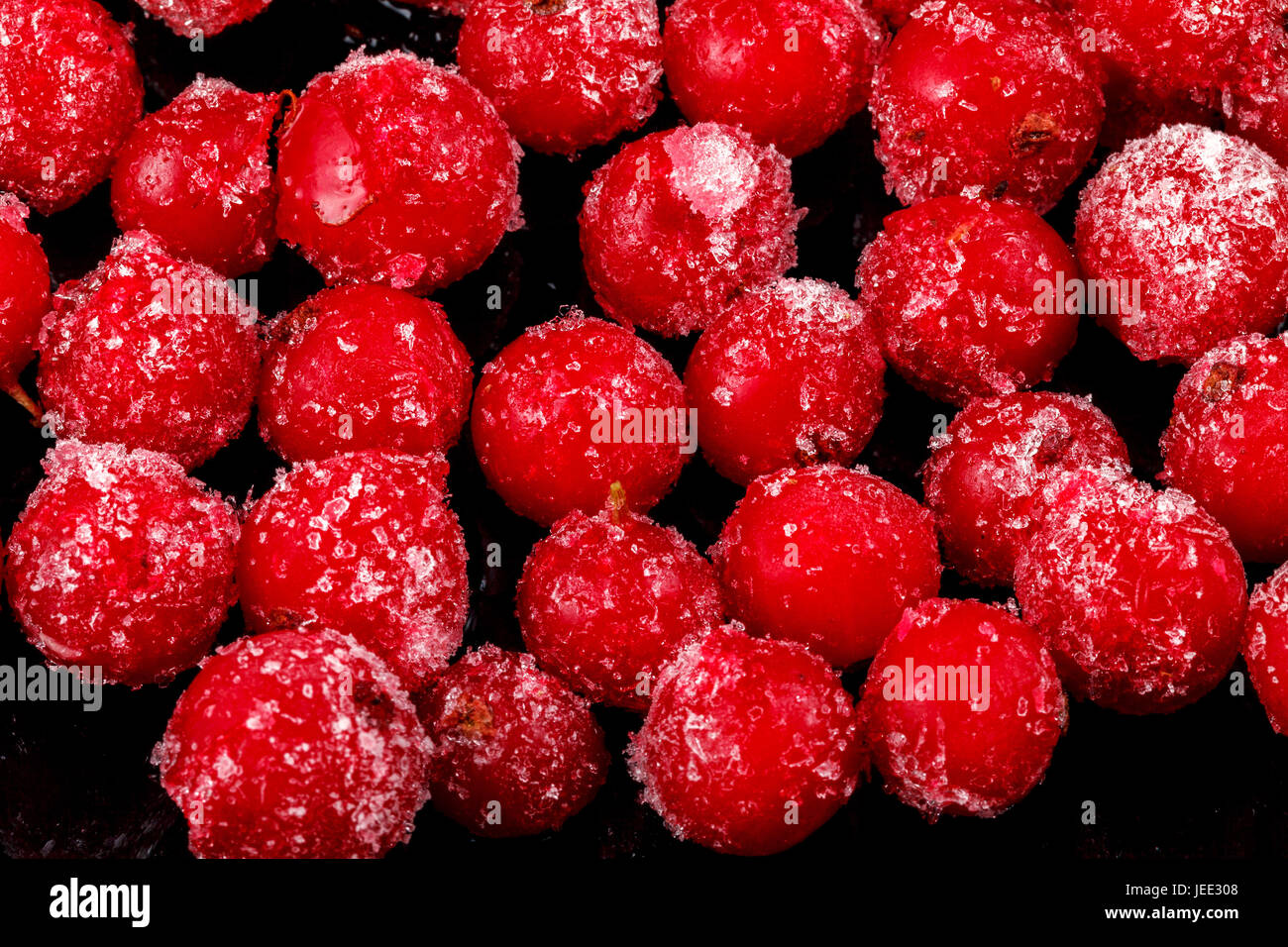 Frozen berries of red currants on a dark background. Close-up Stock Photo