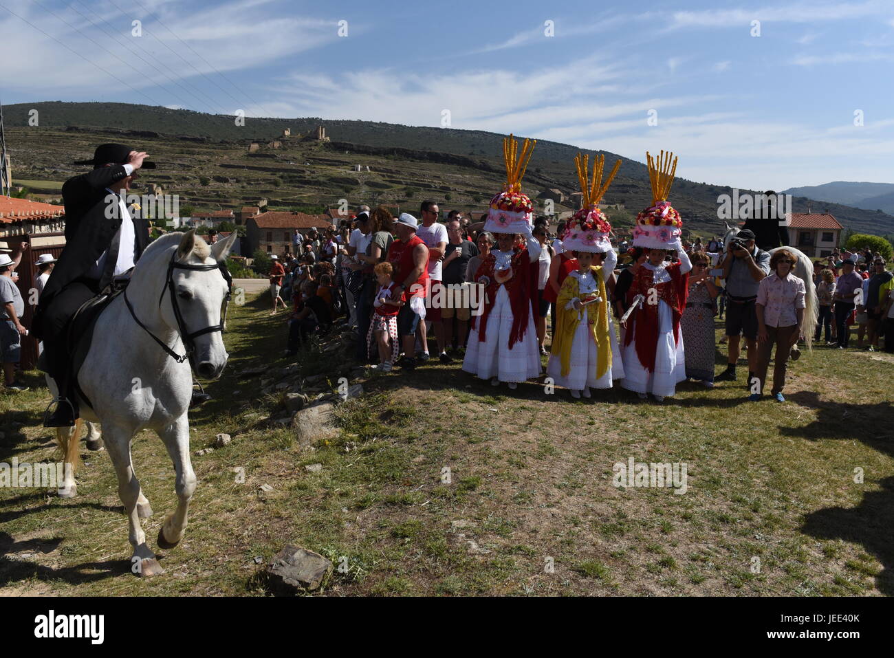 San Pedro Manrique, Spain. 24th June, 2017. A group of women called 'Móndidas' dressed in traditional costumes and wearing huge 'Cestaños', hats decorated with flowers and branches, covered with unleavened bread and colored with saffron, pictured during the celebration of the ancient tradition of 'La Descubierta' in San Pedro Manrique, northern Spain. Credit: Jorge Sanz/Pacific Press/Alamy Live News Stock Photo