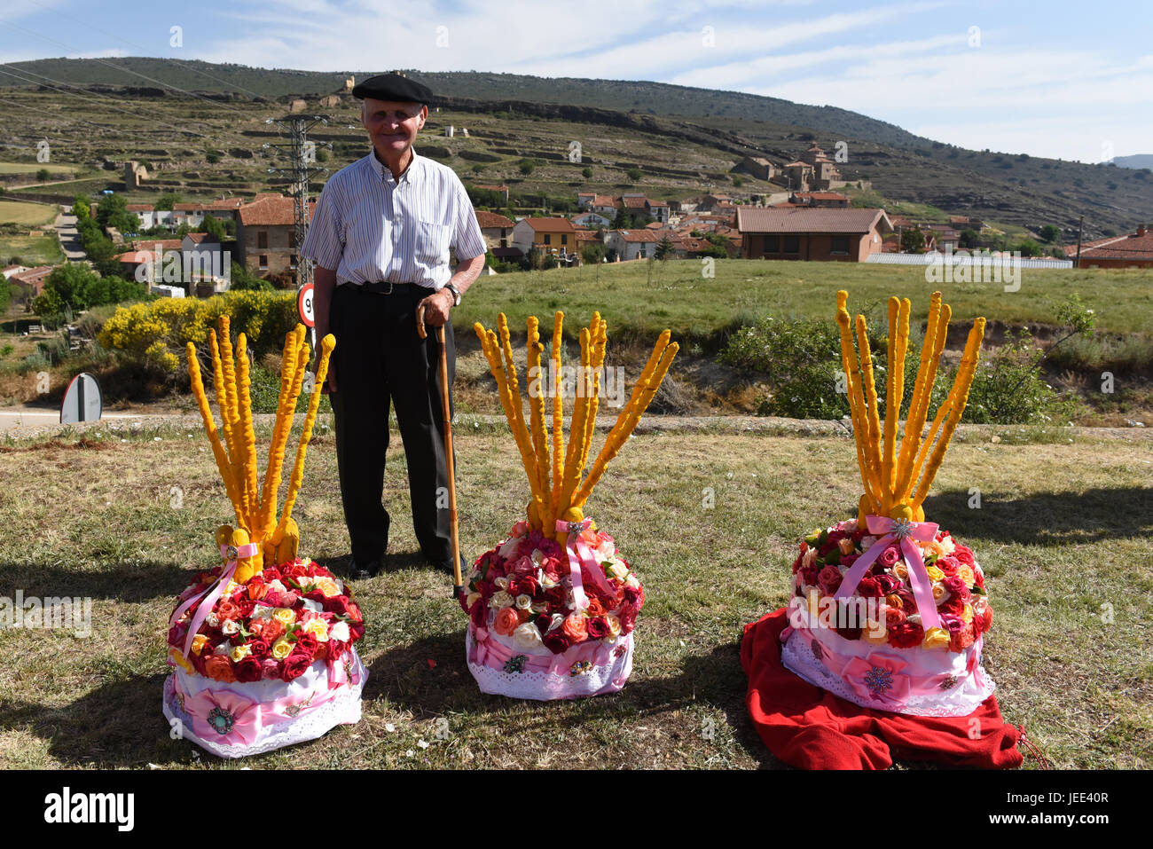 San Pedro Manrique, Spain. 24th June, 2017. An elderly man poses for camera with three 'Cestaños', a hat decorated with flowers and branches, covered with unleavened bread and colored with saffron, pictuerd during the celebration of the ancient tradition of 'La Descubierta' in San Pedro Manrique, northern Spain. Credit: Jorge Sanz/Pacific Press/Alamy Live News Stock Photo