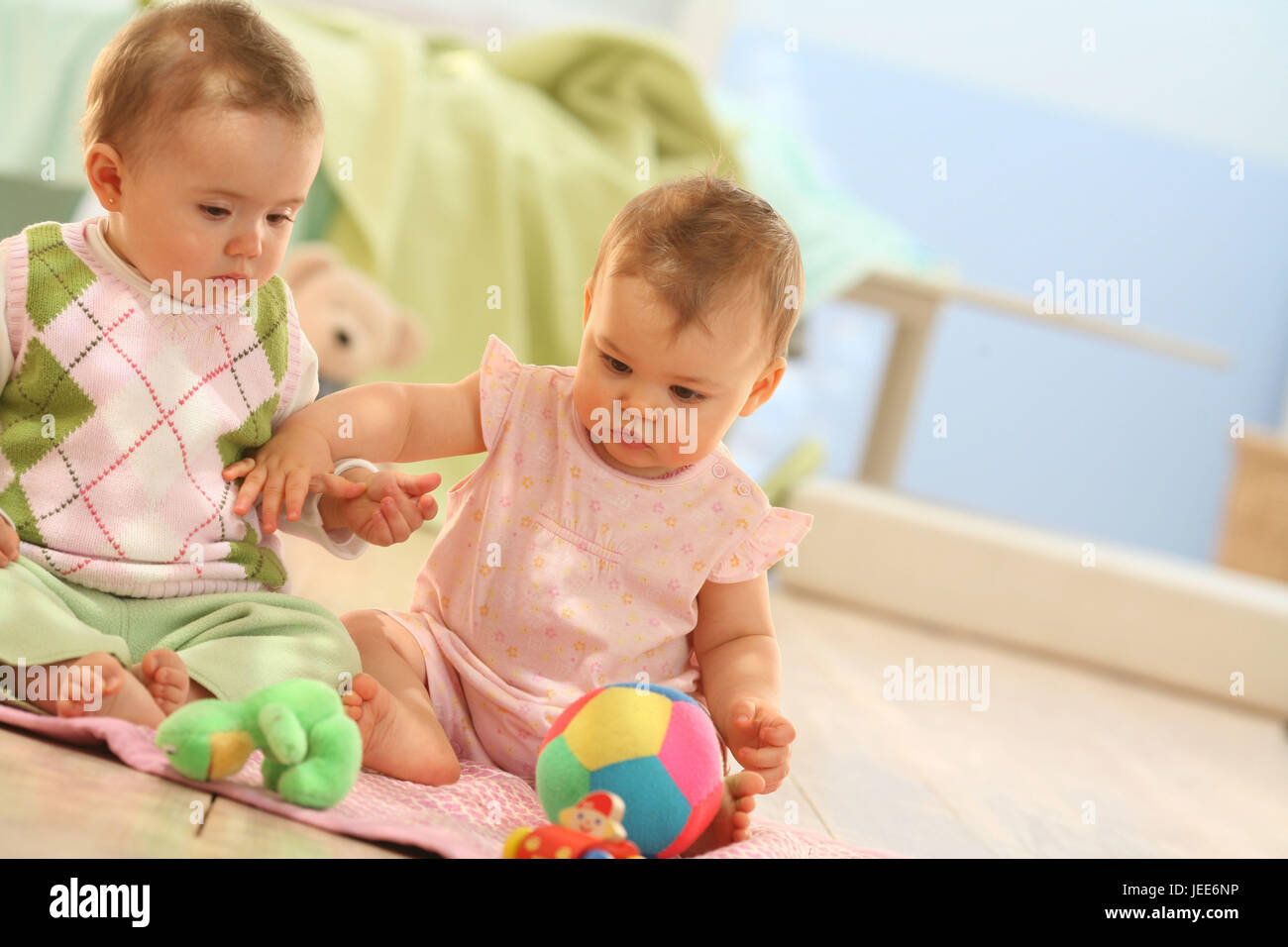two babies, game group, social behaviour, toys, share, try out, Stock Photo