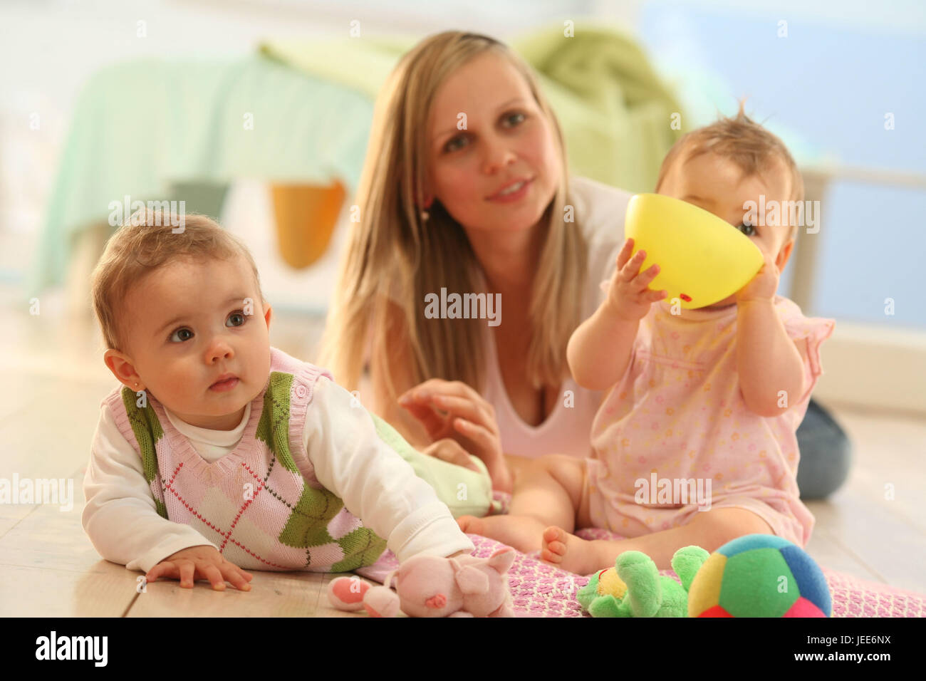 two babies, game group, mother, social behaviour, toys, share, try out, Stock Photo