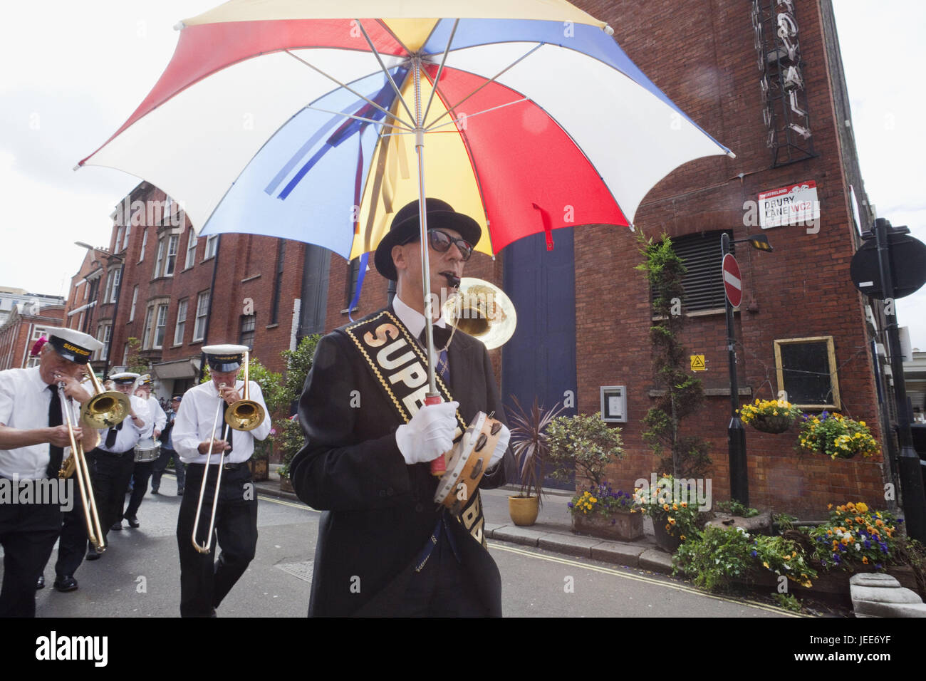 England, London, Covent guards, Brass cord, Annual Street save, birthday of Mr. Punch celebrate, town, street save, conversationist, entertainment, save, cord, band, band, music, musician, person, procession, conductor, umbrella, Stock Photo