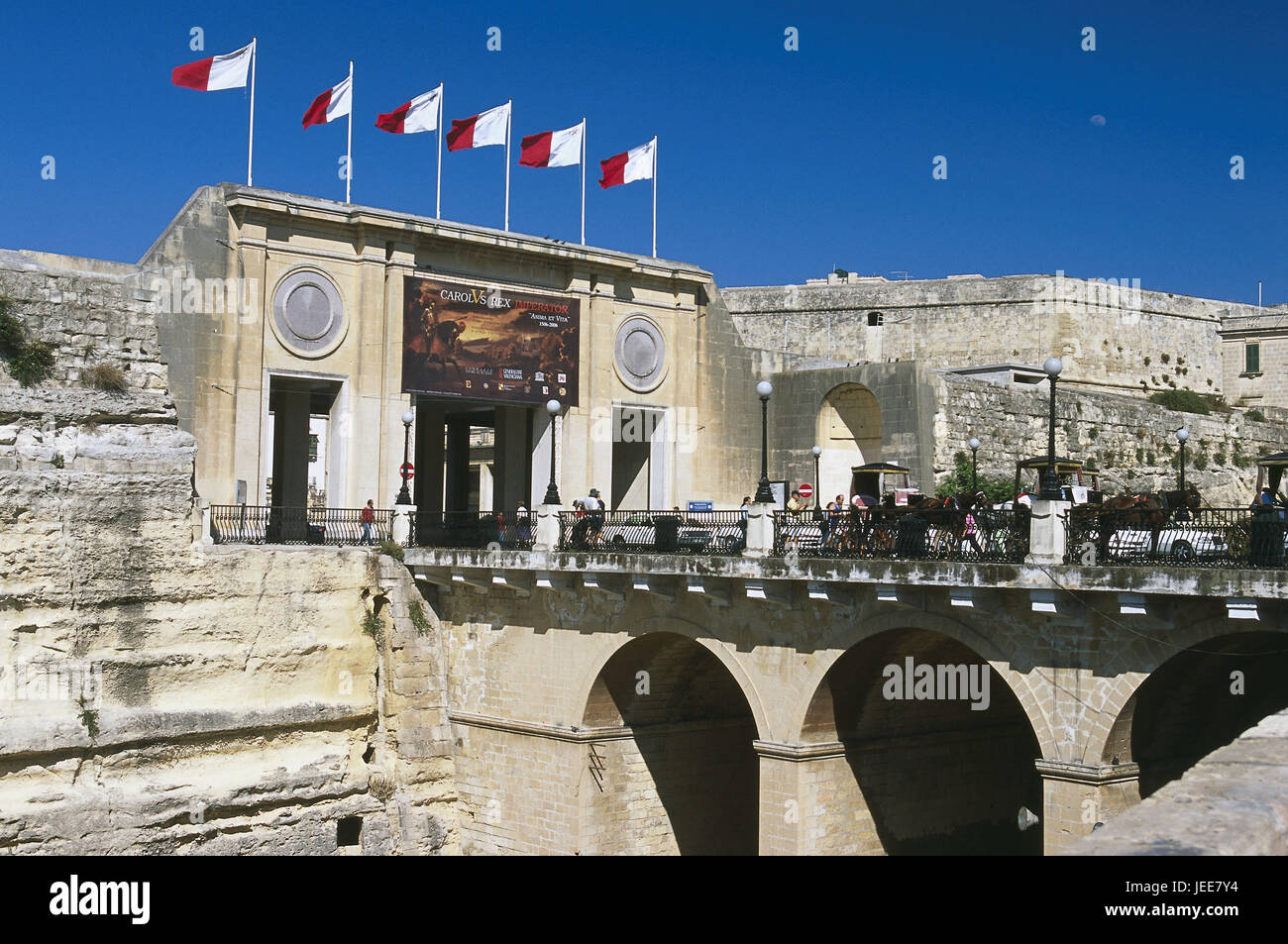 Island Malta, peninsula Sciberras, Valletta, city gates, bridge, traffic, passer-by, Maltese islands, Mediterranean island, capital, town, town view, UNESCO-world cultural heritage, structure, gate, builds in 1968, town gate, input, passage, access road, flags, stone bridge, moat, horse's carriages, cars, town traffic, place of interest, outside, Stock Photo