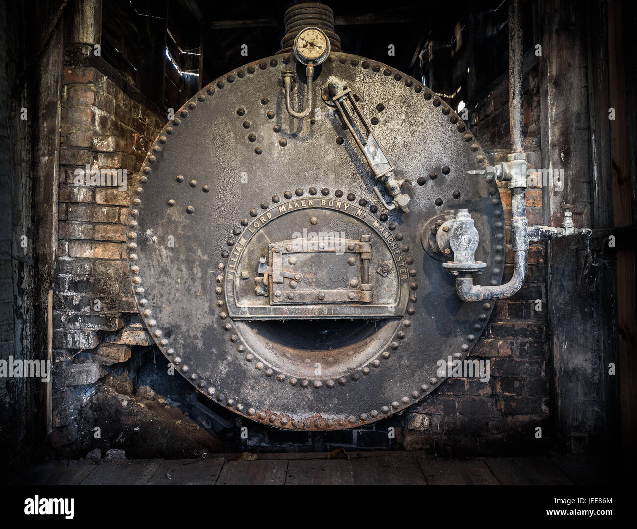 An old cast iron industrial boiler still in it's building ...