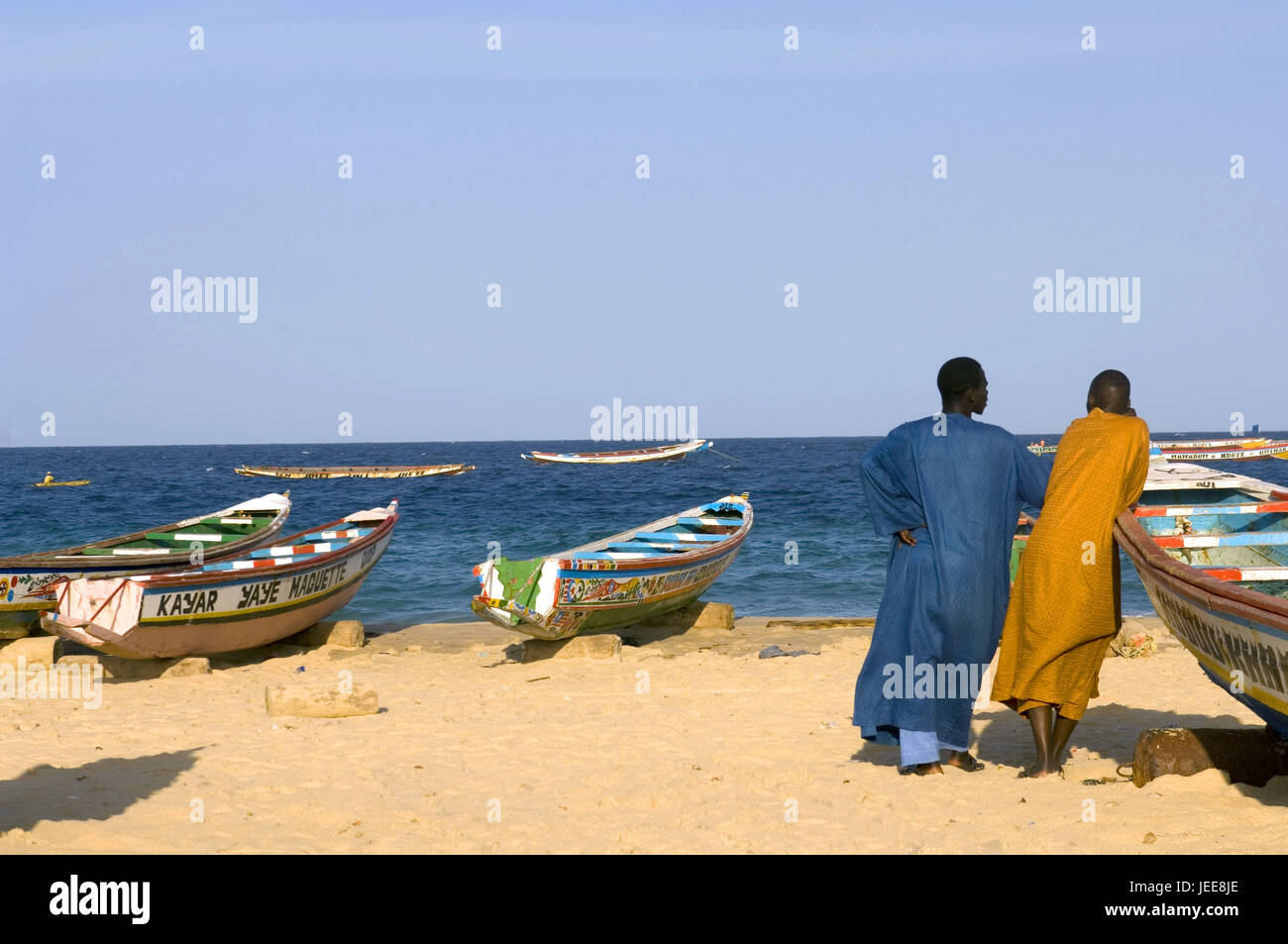 Men, back view, boats, sandy beach, sea, Kayar, Senegal, Stock Photo