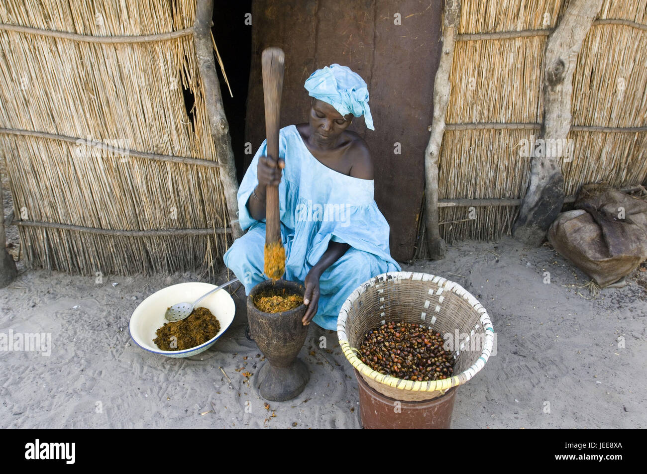 Woman, tappet, palm fruits, mash, vessels, village Sipo, Saloum delta, Senegal, Stock Photo