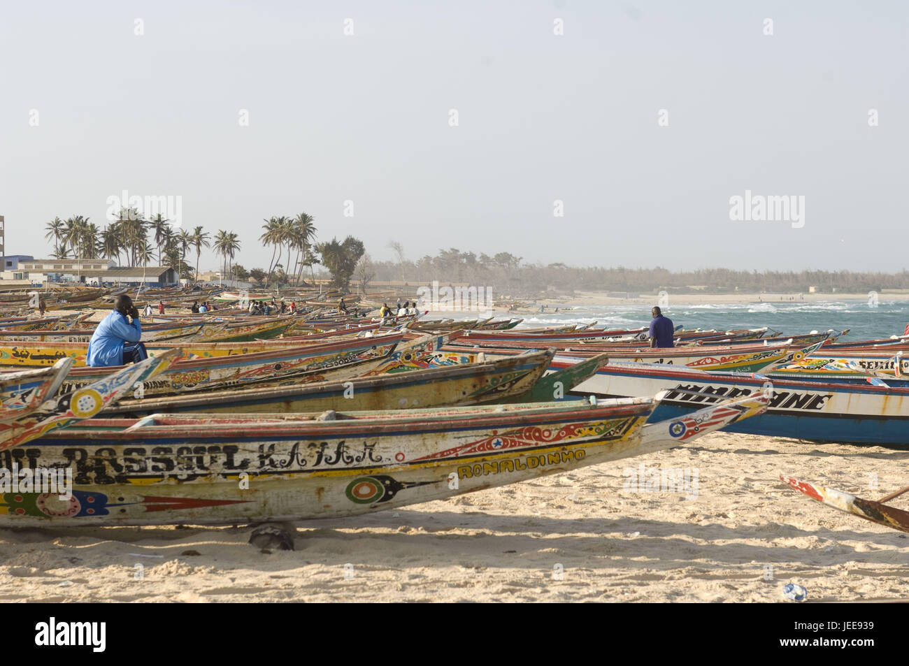 Coastal scenery, boats, men, sandy beach, surf, sea, Kayar, Senegal, Stock Photo
