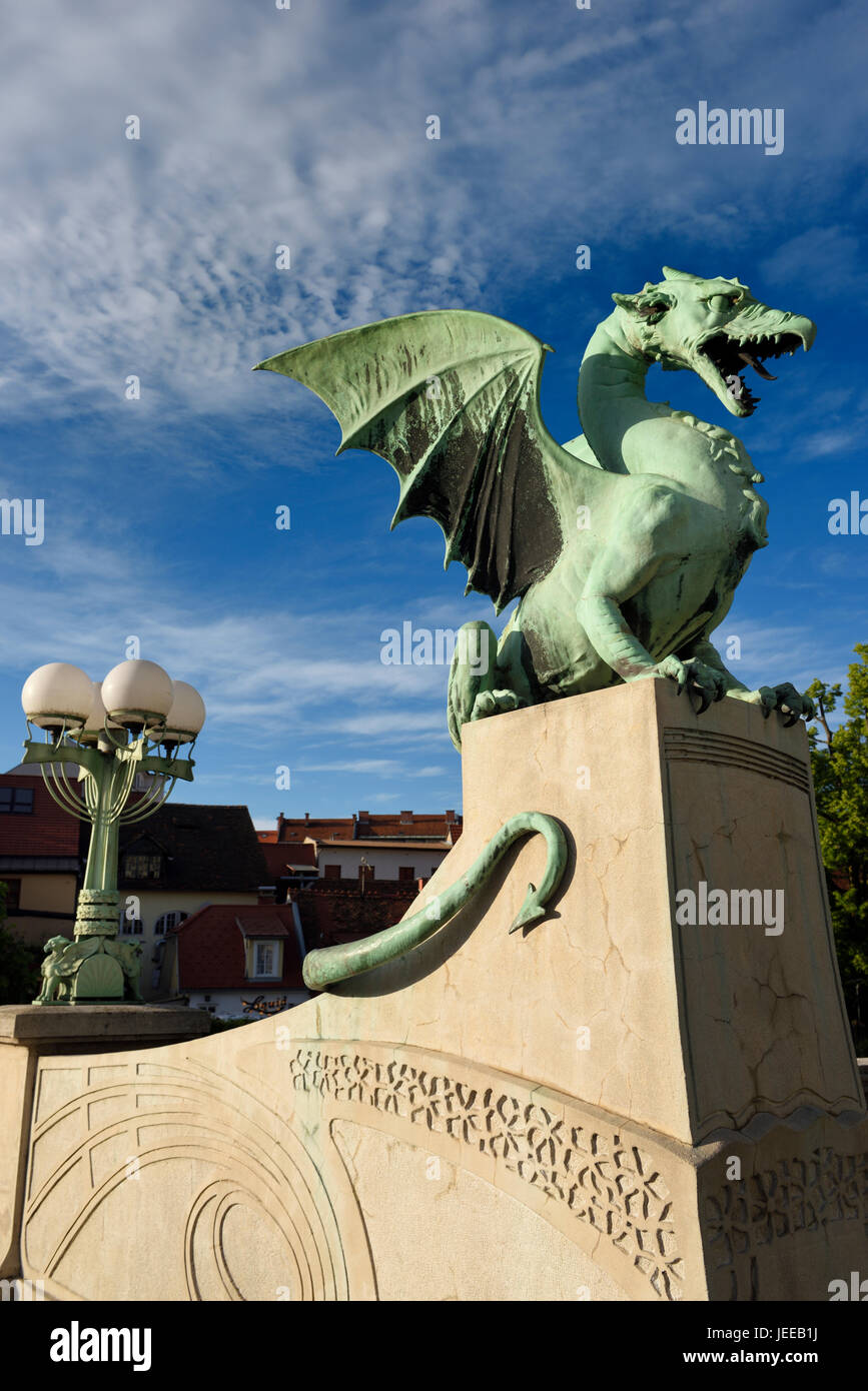 Green copper Dragon statue on concrete pedestal of Dragon Bridge over the Ljubljanica river symbol of Ljubljana Slovenia Stock Photo