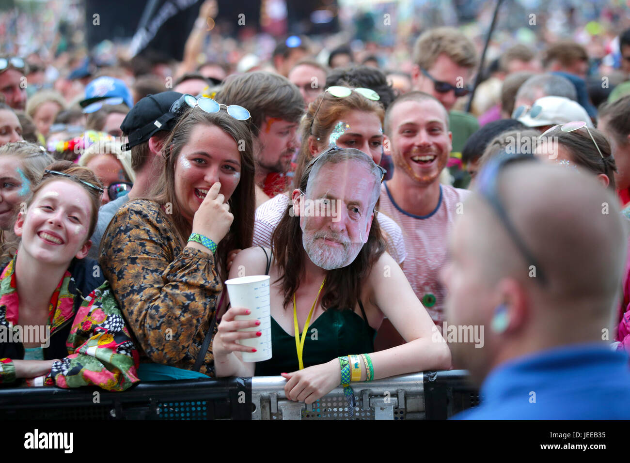 A festivalgoer wearing a Jeremy Corbyn mask as the crowd wait for Lorde ...