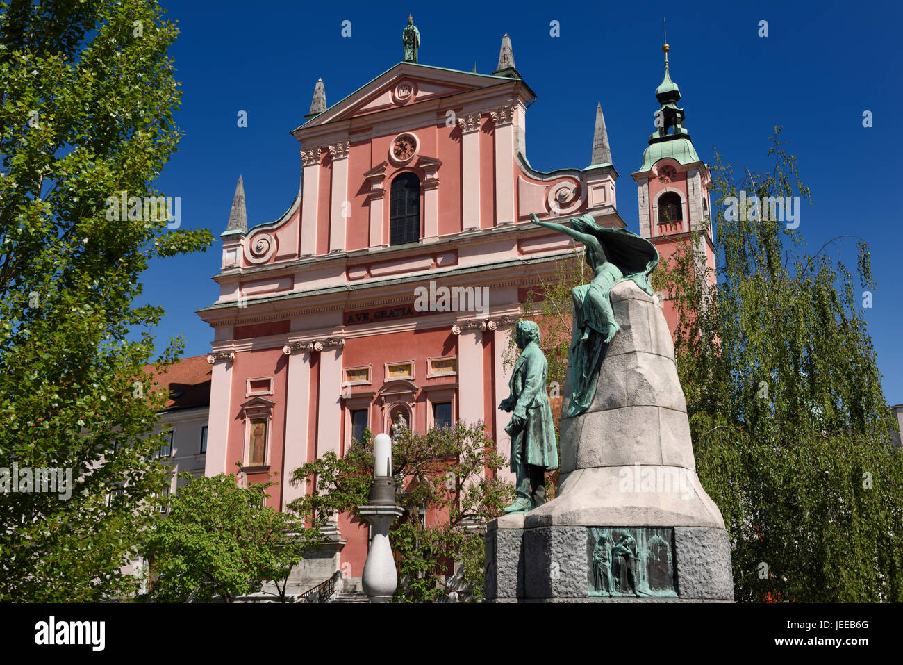 National poet France Preseren statue Monument with muse in front of pink Franciscan Church of the Annunciation in Ljubljana Slovenia Stock Photo