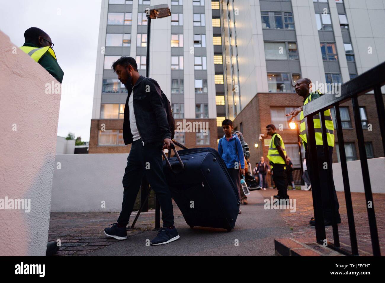 Residents leave the Taplow tower block on the Chalcots Estate in Camden, London, as the building is evacuated in the wake of the Grenfell Tower fire to allow 'urgent fire safety works' to take place. Stock Photo