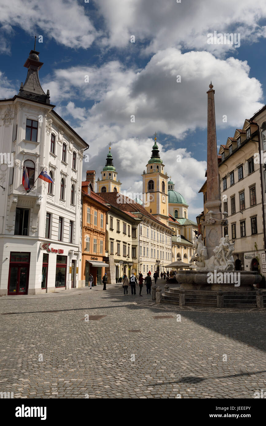 The Town Square of Ljubljana Slovenia with the Robba Fountain of Three Rivers obelisk and the city Cathedral St Nicholas Catholic church Stock Photo