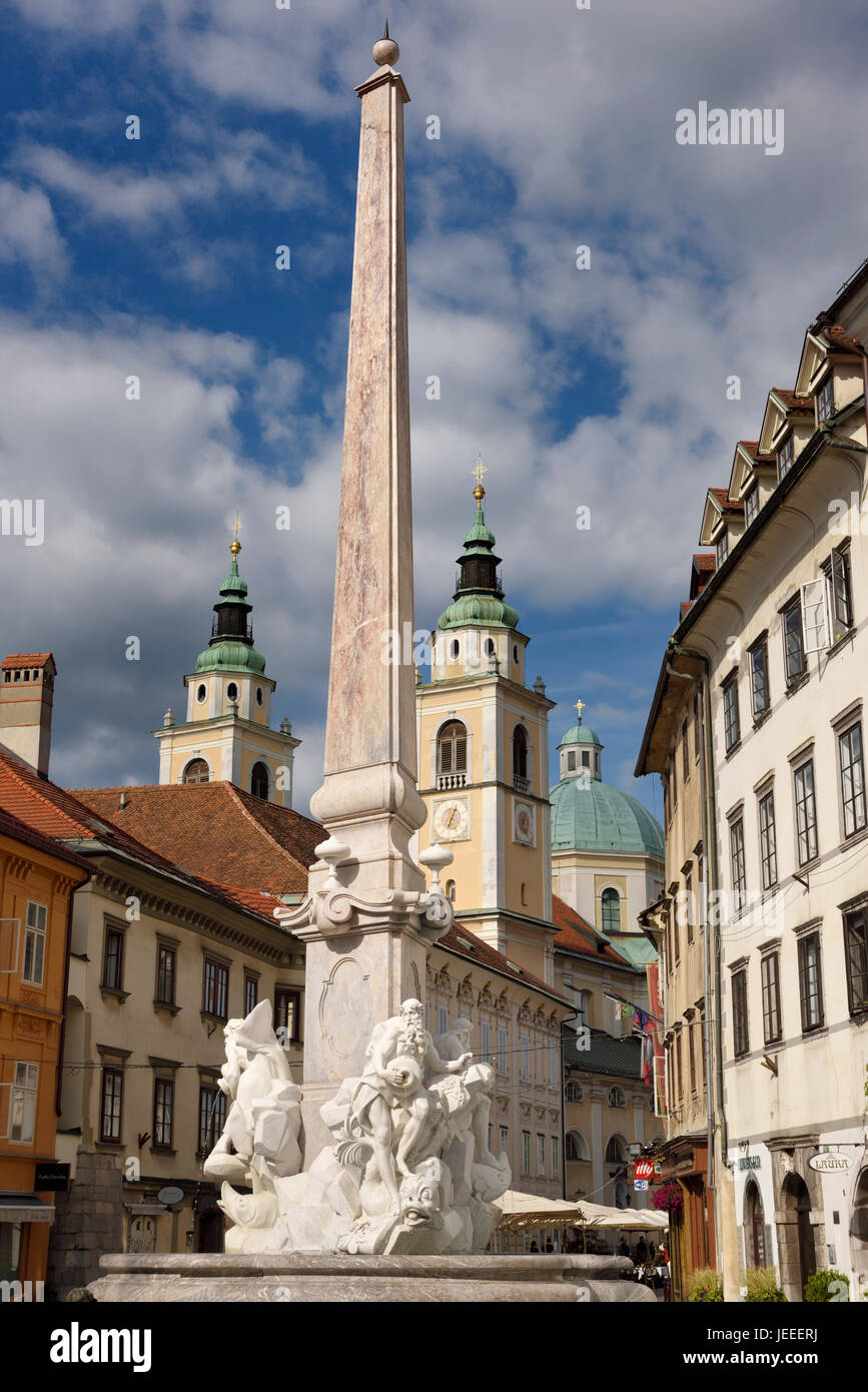 Robba Fountain of the Three Rivers in the Town Square of Ljubljana capitol city of Slovenia with St Nicholas Ljubljana Cathedral catholic church Stock Photo