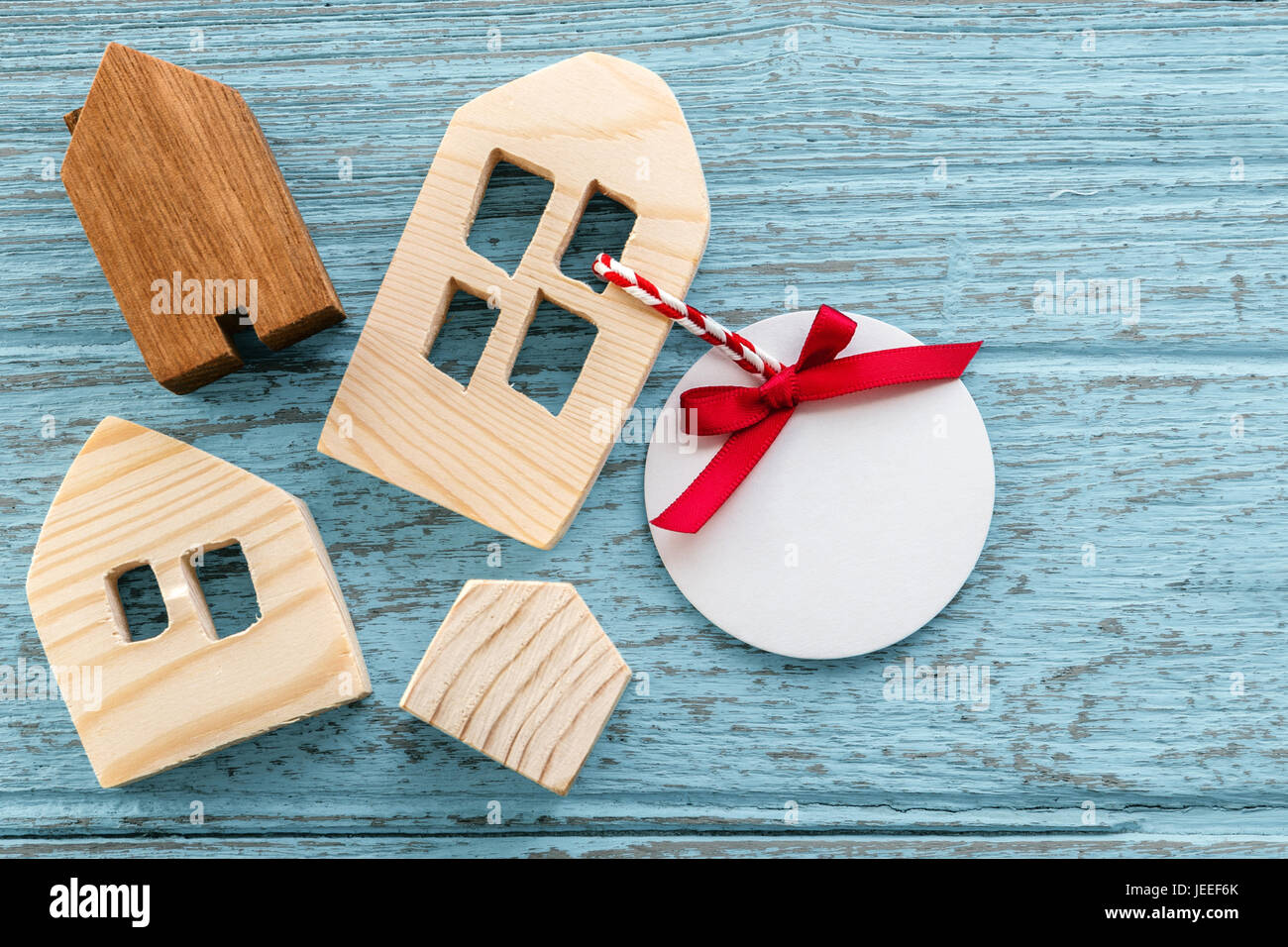 Wood house model and white blank paper tag Stock Photo
