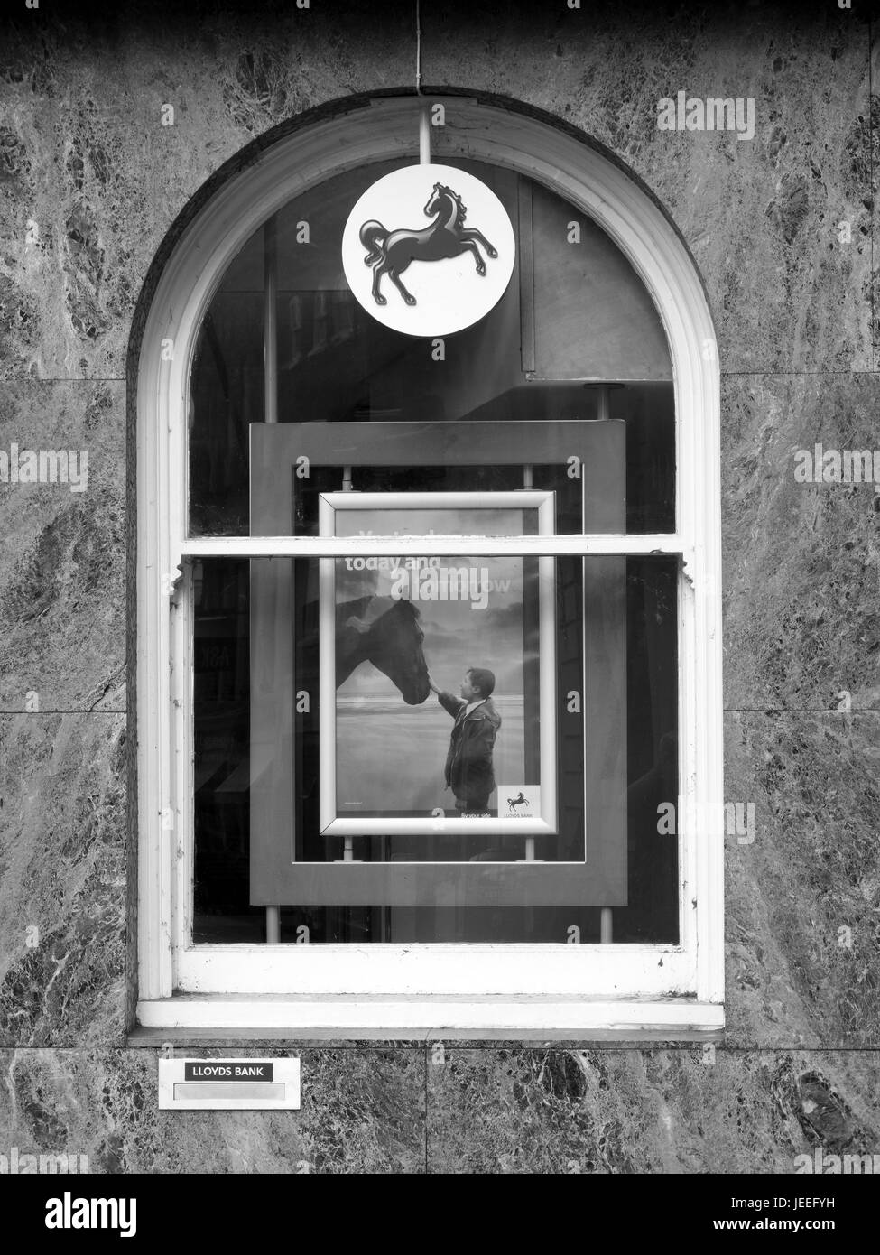Lloyds bank sign and advertising poster in window, British retail and commercial bank, originally founded in 1765 Stock Photo