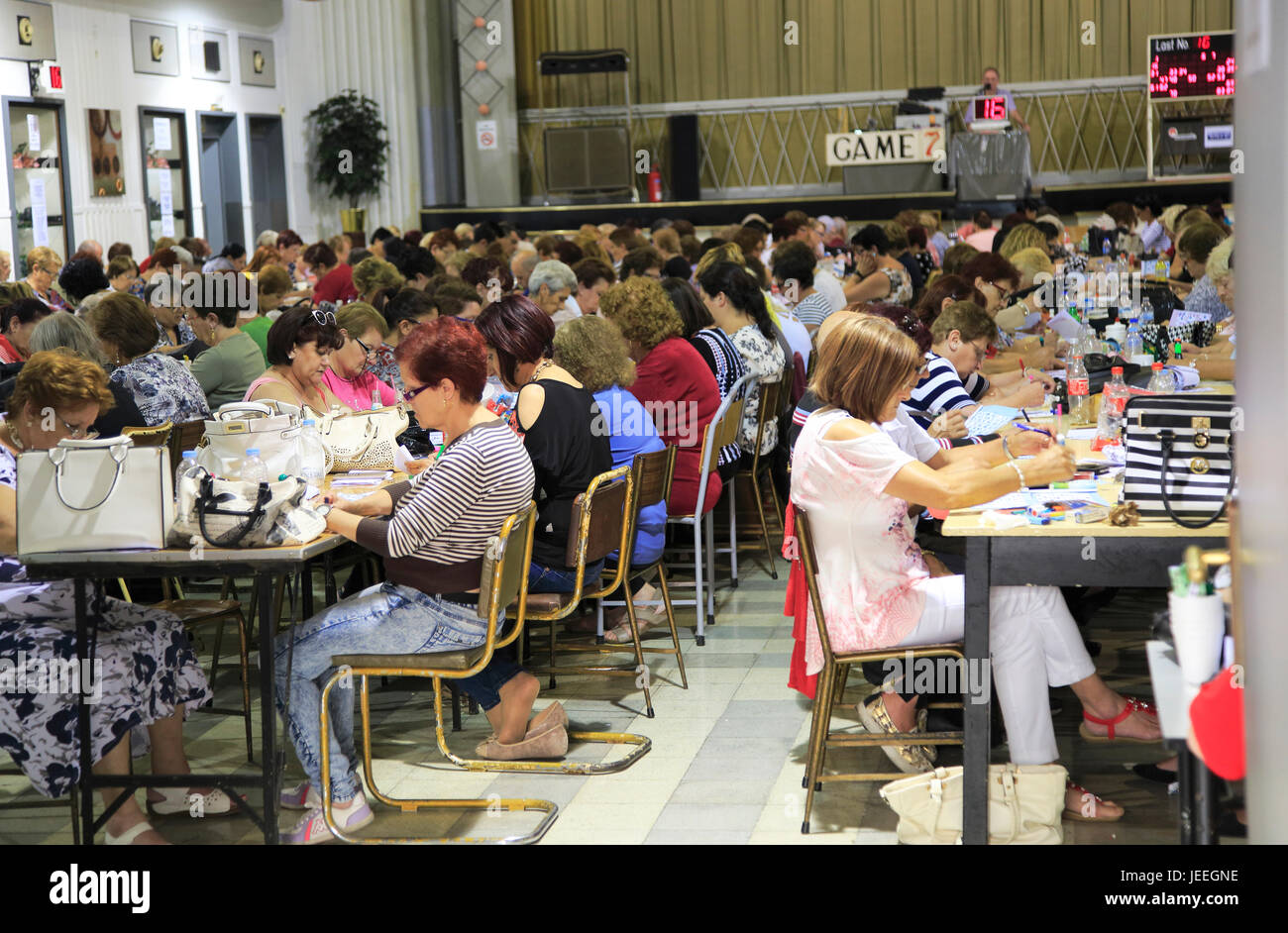Large group of people mainly women playing bingo, Tarxien, Malta Stock