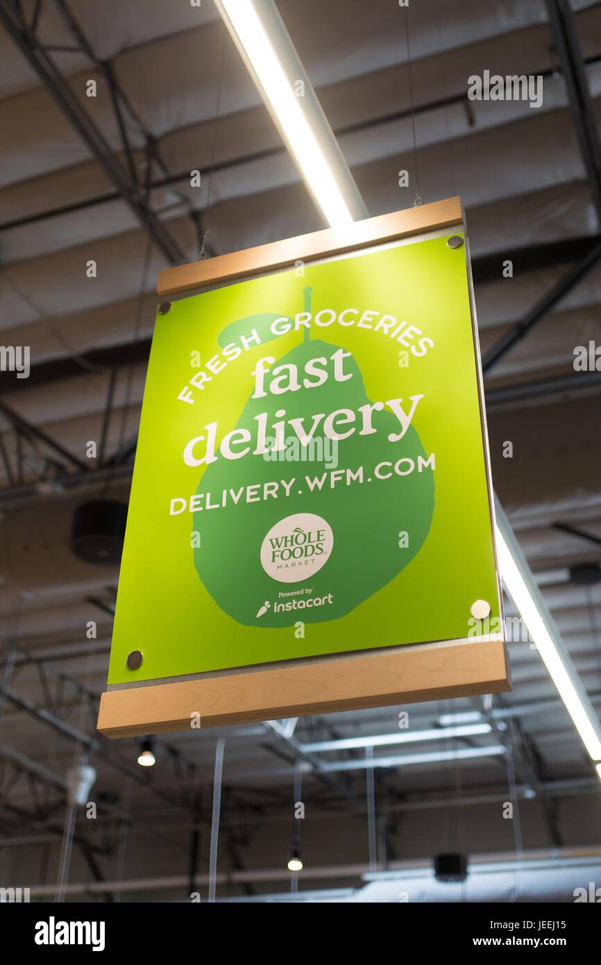 A sign advertises grocery delivery at the Whole Foods Market grocery store  in Dublin, California, June 16, 2017 Stock Photo - Alamy