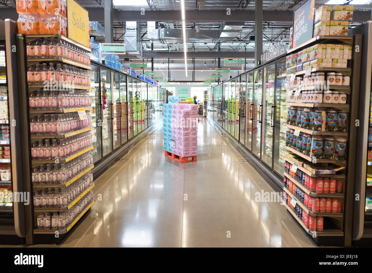 View down a refrigerated food aisle at the Whole Foods Market grocery store in Dublin, California, June 16, 2017. Stock Photo