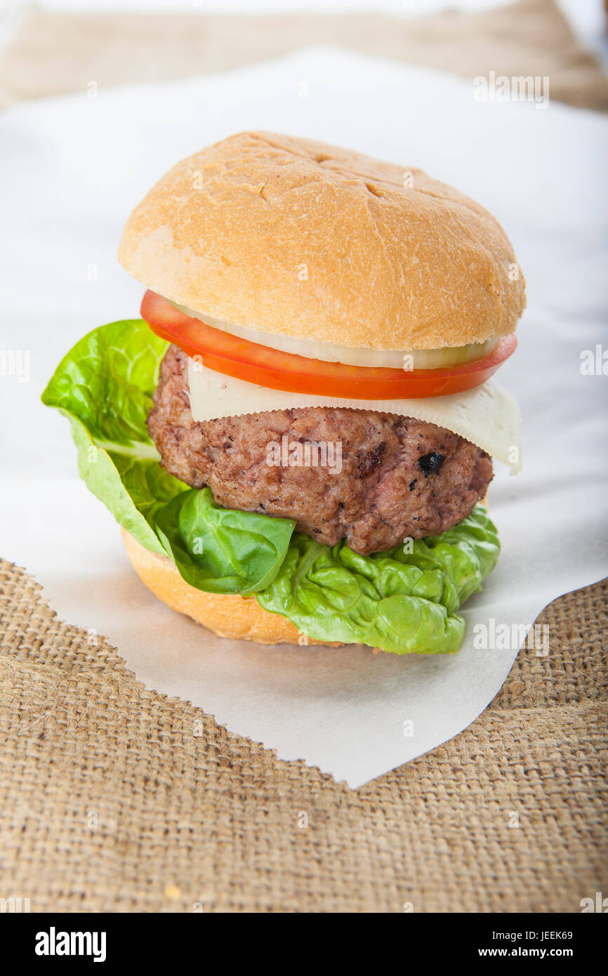 Giant homemade burger classic american cheeseburger on brown sack Stock Photo