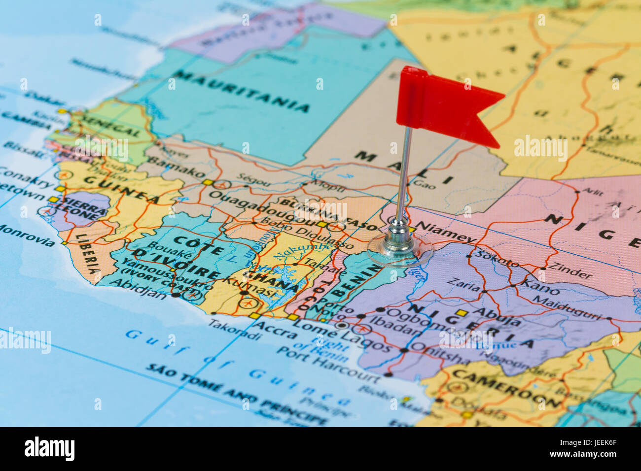 Photo of Benin marked by red flag in holder. Country on African continent. Stock Photo