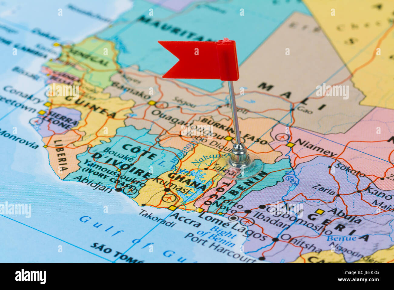 Photo of Togo marked by red flag in holder. Country on African continent. Stock Photo