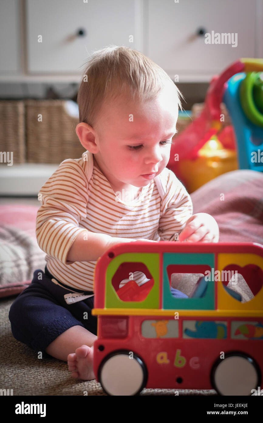 Baby boy playing with toys Stock Photo - Alamy