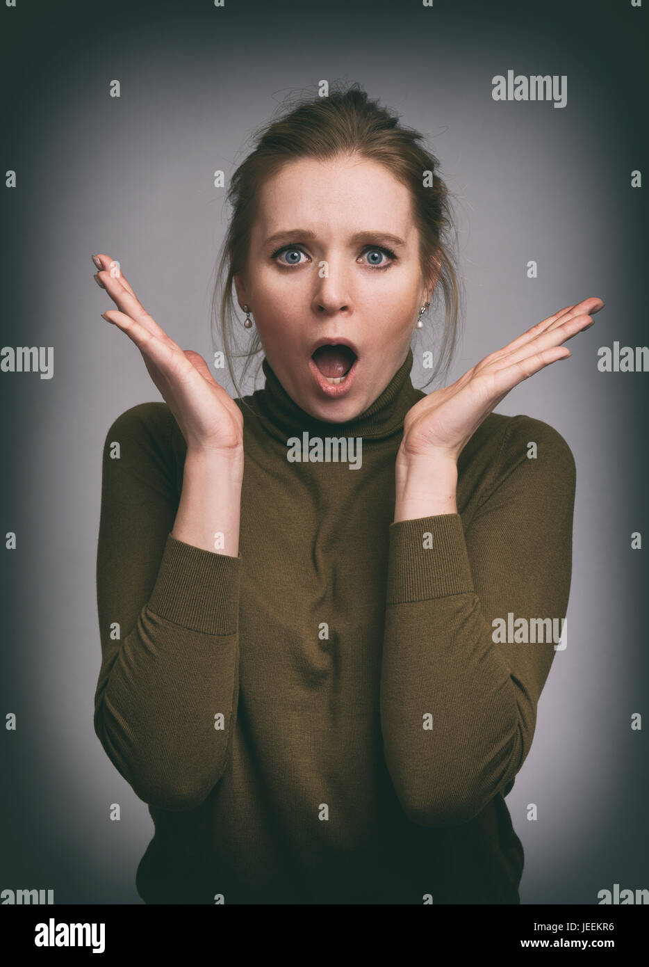 Shocked pretty girl. Beautiful young woman surprised Stock Photo