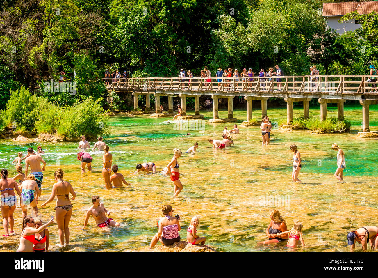 The wooden bridge allows access for tourists to cross the Krka River in front of Skradinski buk Waterfall at Krka National Park in Croatia Stock Photo