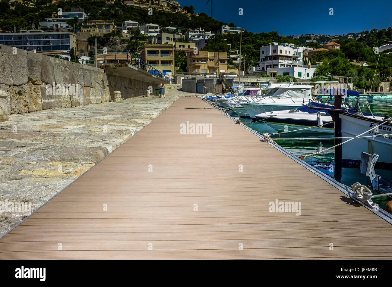 A pontoon beside boats tied up in port Stock Photo