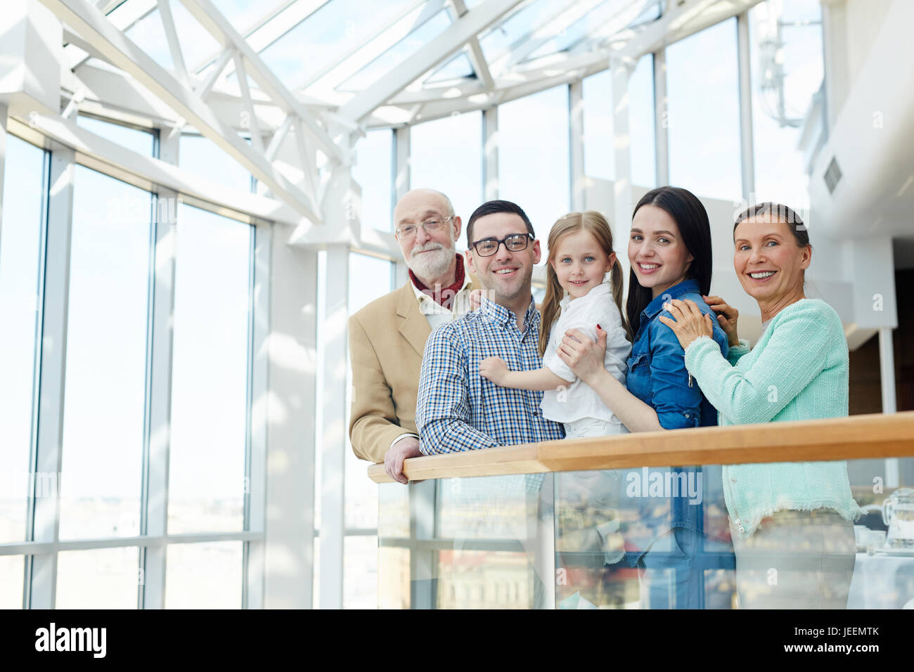 Happy big family of little girl, young and senior couples looking at camera Stock Photo