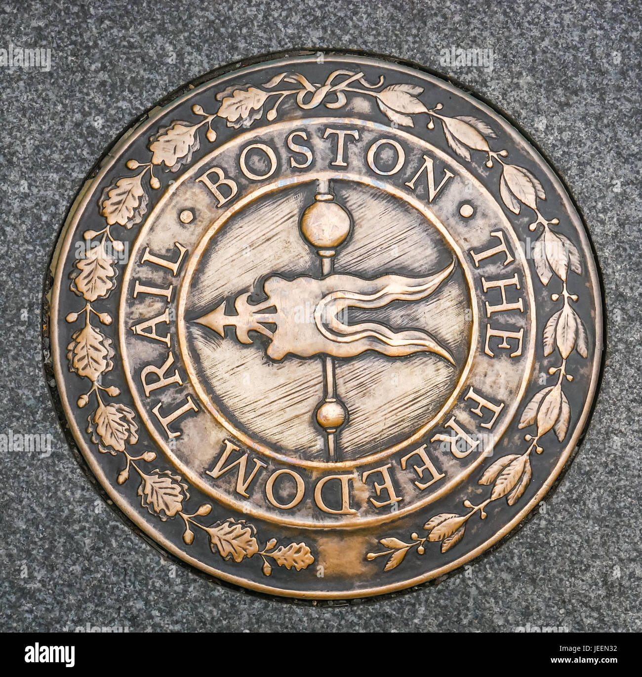 Close up of brass marker on pavement, designating route of tourist Boston Freedom Trail, downtown Boston, Massachusetts, USA Stock Photo