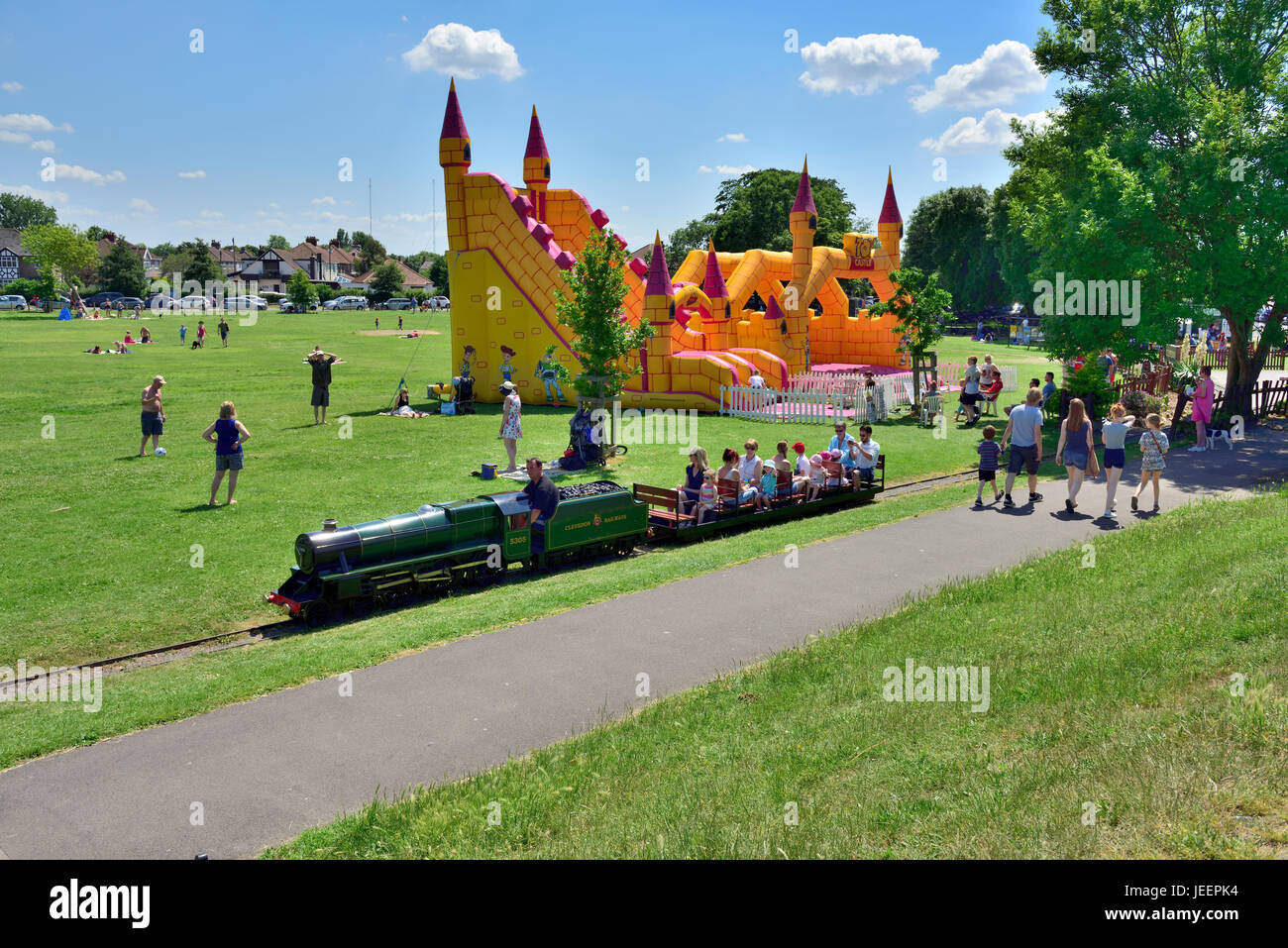 Summer at the seaside visiting Clevedon Salthouse Park, North Somerset, with miniature railway and bouncy castle Stock Photo