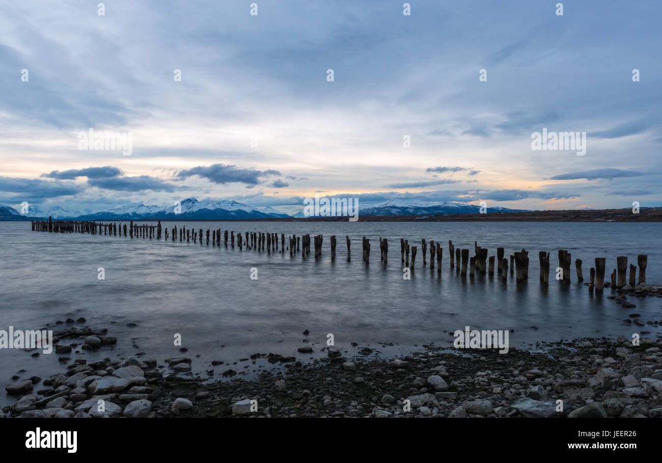 Sunset landscape along the Last Hope Sound with an old pier in the city of Puerto Natales, Patagonia, Chile. Stock Photo